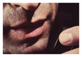 His Voice fine art photograph by LiAns JadAn featuring an extreme close-up of a man speaking into a vintage telephone in dramatic low light