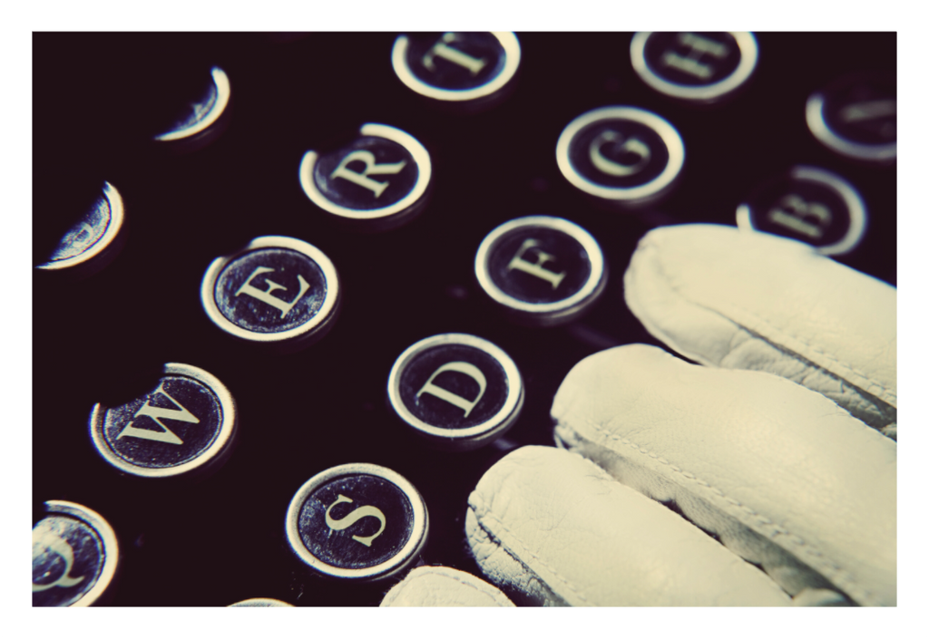 In Her Hands fine art photograph by LiAns JadAn featuring white-gloved hands resting over the keys of a vintage typewriter
