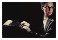 Overtime fine art photograph by LiAns JadAn featuring a secretary in glasses seated at a vintage typewriter and looking off-frame