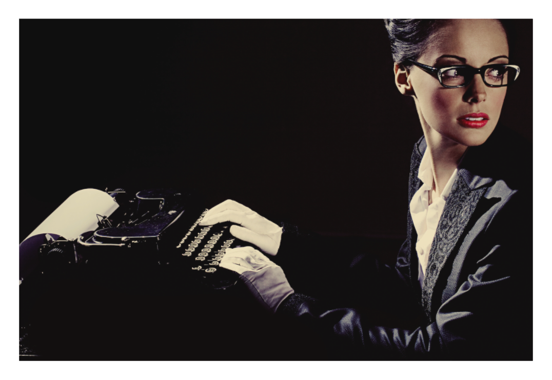 Overtime fine art photograph by LiAns JadAn featuring a secretary in glasses seated at a vintage typewriter and looking off-frame