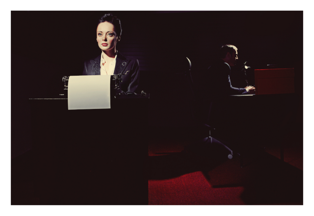 The Arrangement fine art photograph by LiAns JadAn featuring a secretary at a typewriter with her employer working in the shadows behind her